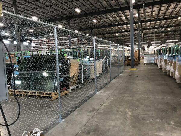 Commercial chain link security fence installed inside an industrial warehouse in Orlando, FL