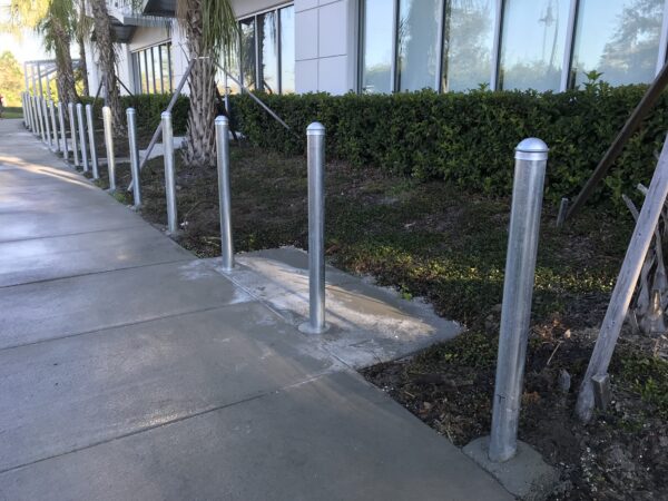 Commercial galvanized steel security bollards installed outside an office building in Orlando, FL