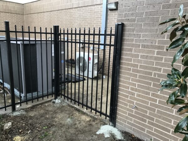 Commercial black aluminum fence installed around rooftop HVAC equipment at a commercial property in Orlando, FL.