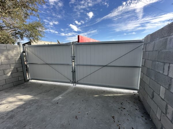 Commercial white vinyl dumpster enclosure double gate installed in Orlando, FL