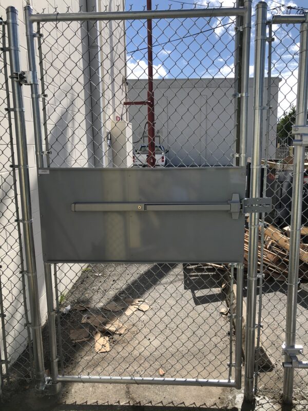 Commercial chain link security gate with panic bar installed at an industrial facility in Orlando, FL